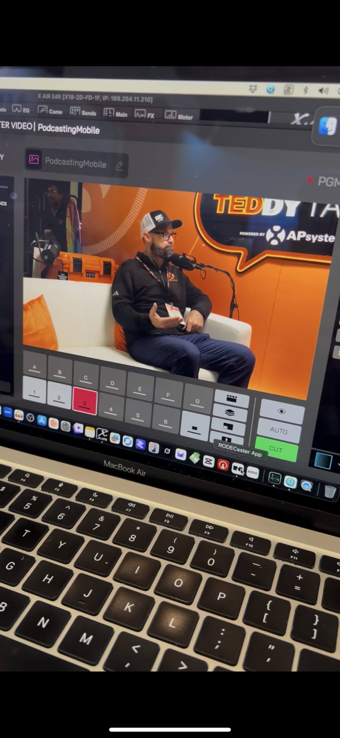 Live-switching a booth interview between camera angles on a laptop at RE+
