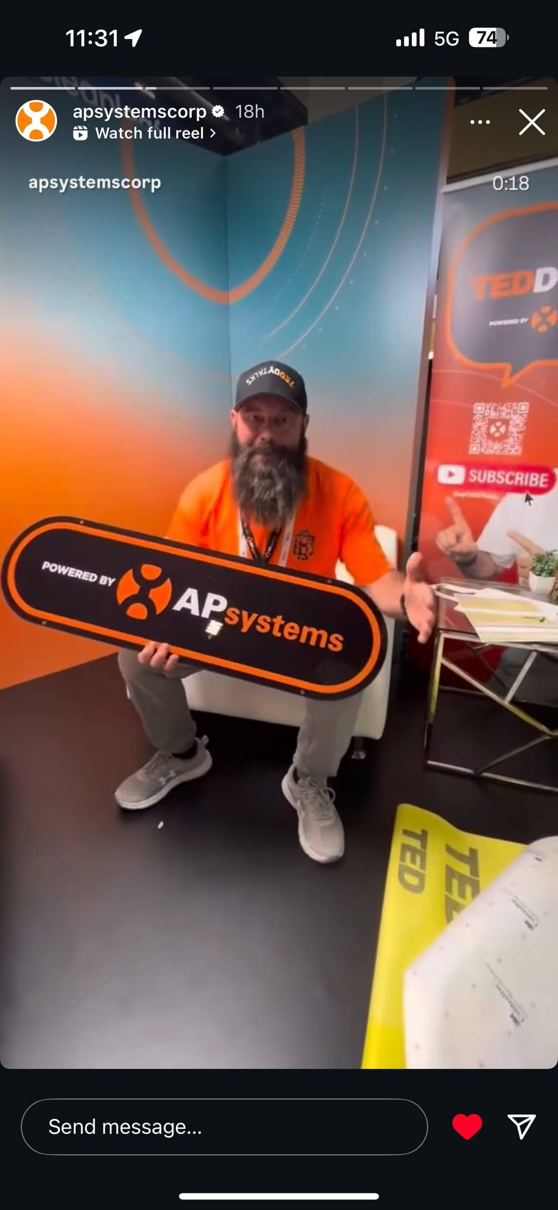 Teddy Hodges of AP Systems on set holding a Powered by APsystems sign