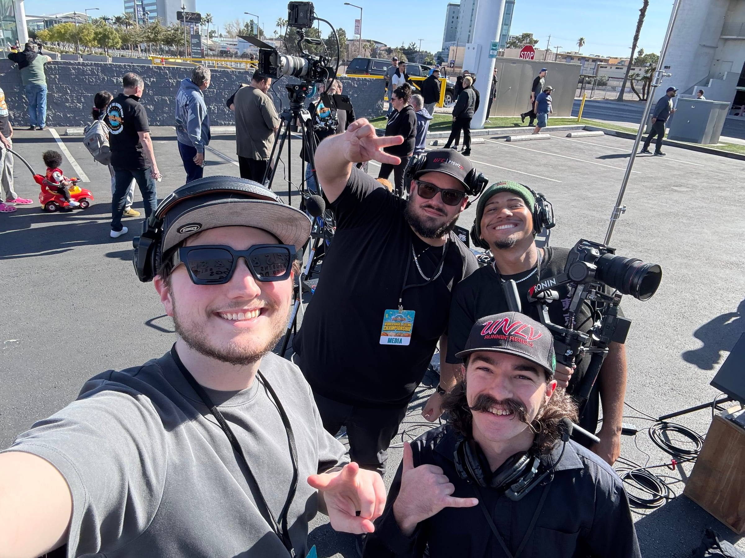 People with cameras and headsets at an outdoor event shoot